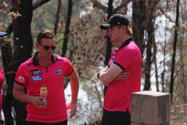 Sydney Sixers players Daniel Hughes and Lloyd Pope reflect on the tragic situation at fire ravaged Nymboida during a team visit ahead of their BBL09 fixture with Adelaide Strikers at C.Ex International Stadium in Coffs Harbour on Sunday, 5th January, 2019.