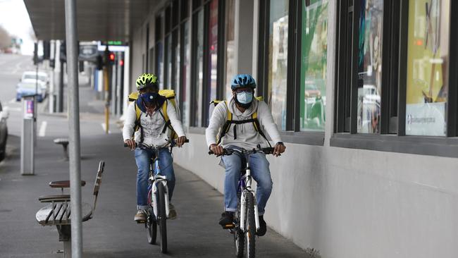 Takeaway delivery riders in their masks while working in Geelong. Picture: Alan Barber