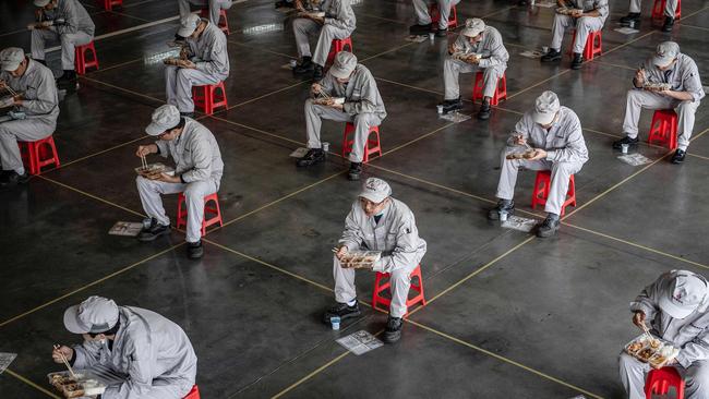 Employees eating lunch at an auto plant of Dongfeng Honda in Wuhan. Picture: AFP