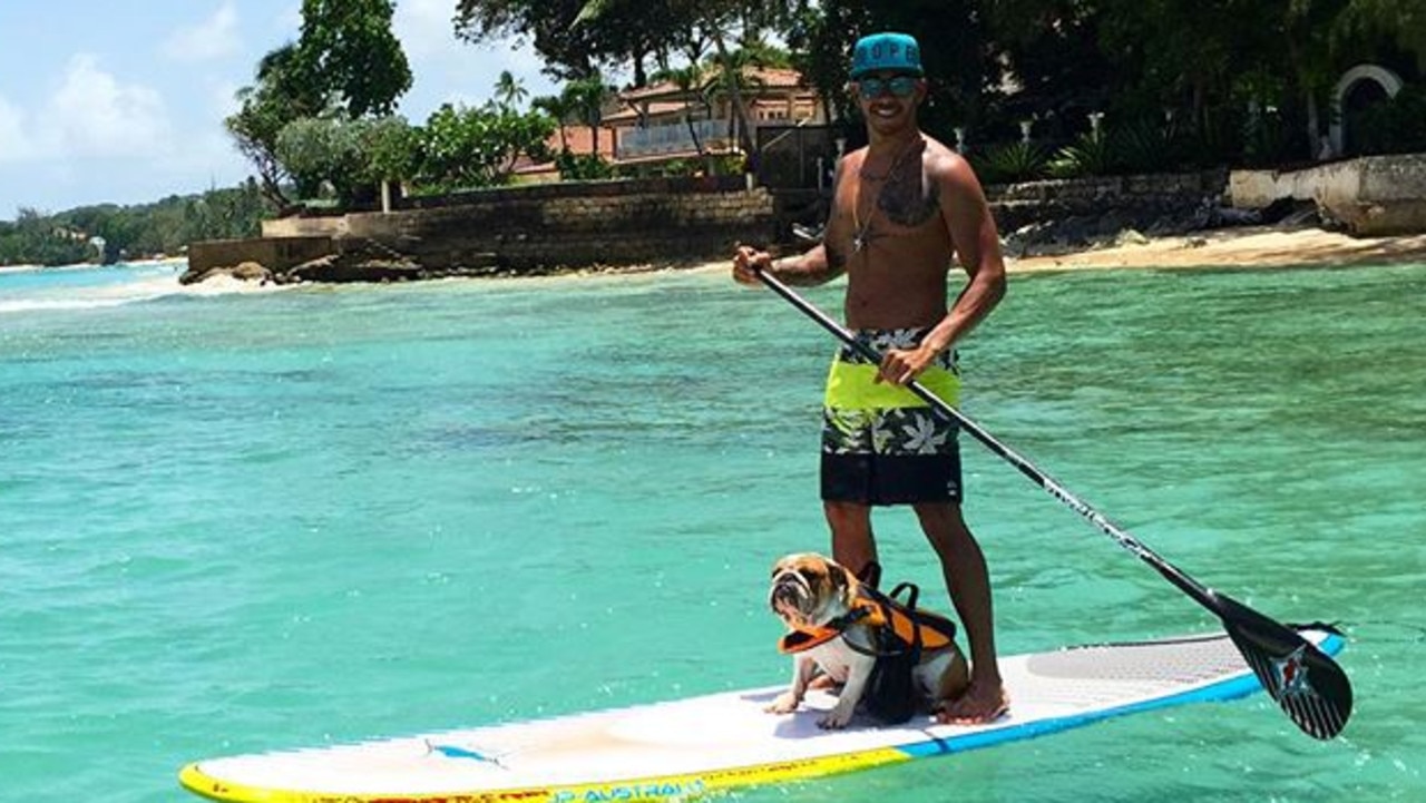 Stand-up paddleboarding with his dog “Coconut”. Picture: Instagram