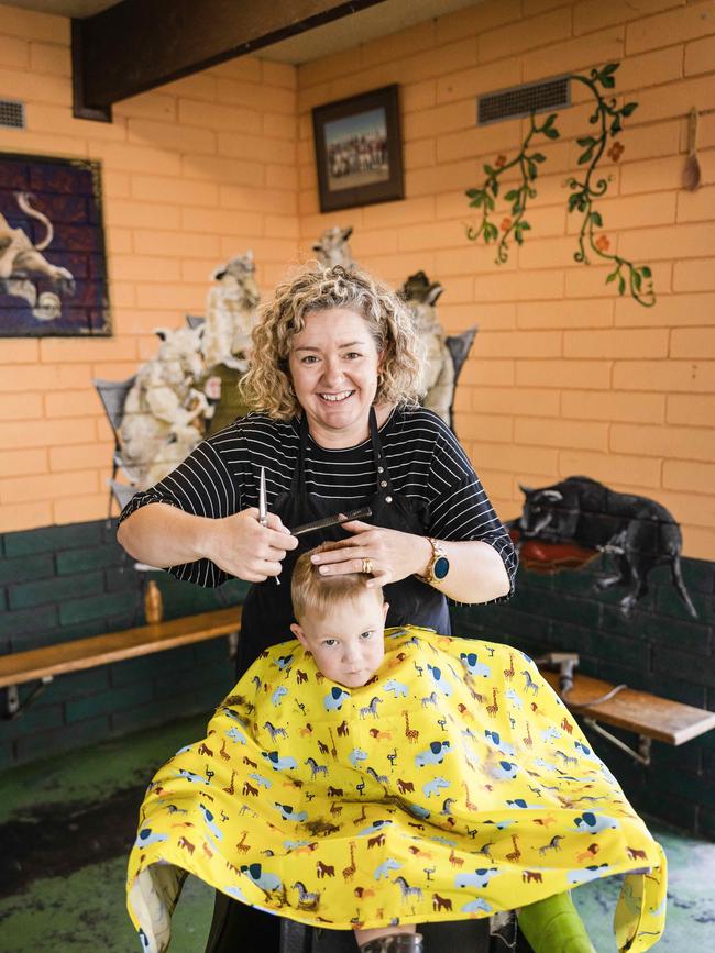 Warrnambool hairdresser Brooke Nevill with young customer Ned Kelson. Photo: Nicole Cleary