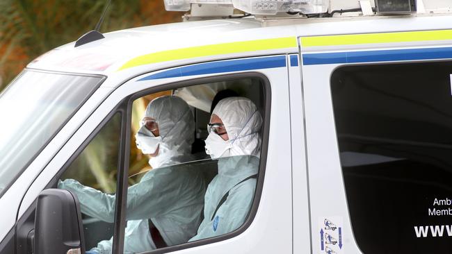 Paramedics in hazmat suits arrive at Avalon Airport near Melbourne. Picture: Glenn Ferguson