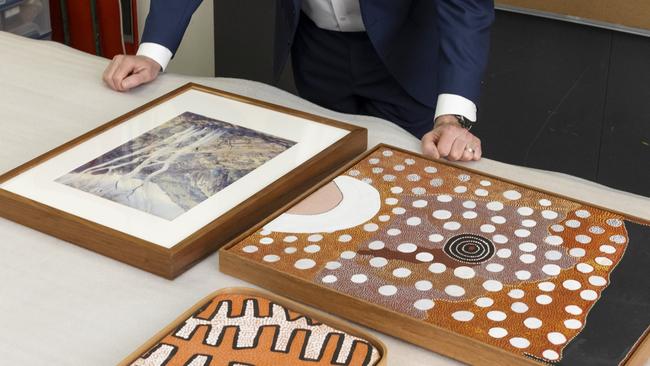 Federal Arts Minister Tony Burke with Namatjira's Central Australian Landscape, Sunrise chasing away the night and Corroboree site two, which will be on display at Araluen Arts Centre from June.