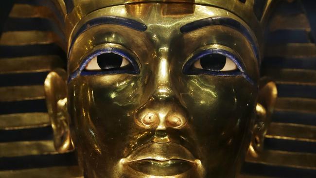 The gold mask of King Tutankhamun is seen in a glass case during a press tour, in the Egyptian Museum near Tahrir Square, Cairo, Egypt, Saturday, Jan. 24, 2015. German restoration specialist, Christian Eckmann, summoned to Cairo to examine the damaged burial mask, spoke at a packed news conference Saturday at the Egyptian museum, saying that epoxy used to glue the mask's beard back on can be removed and the mask properly restored. Eckmann said the beard, which has been detached before from the mask and had likely loosened over the years, was accidentally knocked off last August during work on the relic’s lighting. (AP Photo/Hassan Ammar)