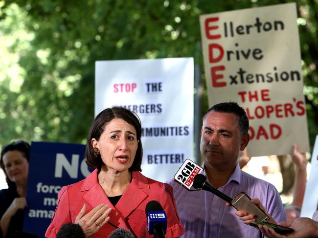 NSW Premier Gladys Berejiklian and Deputy Premier John Barilaro announcing the NSW Government’s new Cabinet as protesters work to derail the announcement. Picture: Kym Smith