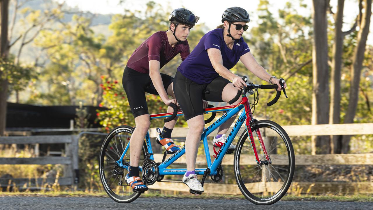 Fifteen-year-old Mitchell Wilkes, pictured training with mum Lisa Wilkes, has a degenerative eye condition and competes in tandem triathlon, Thursday, October 17, 2024. Picture: Kevin Farmer