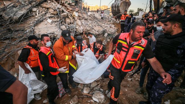 Rescue workers retrieve a body from the rubble in Gaza. Picture: Getty Images