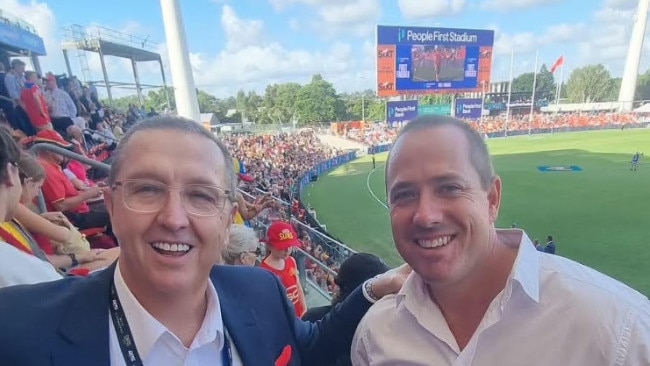 Gold Coast Division 11 candidate Dan Doran with Mark Witheriff (on the left) at the first home games for the Suns, taking a rare break in the lead-up to the March 16 poll.