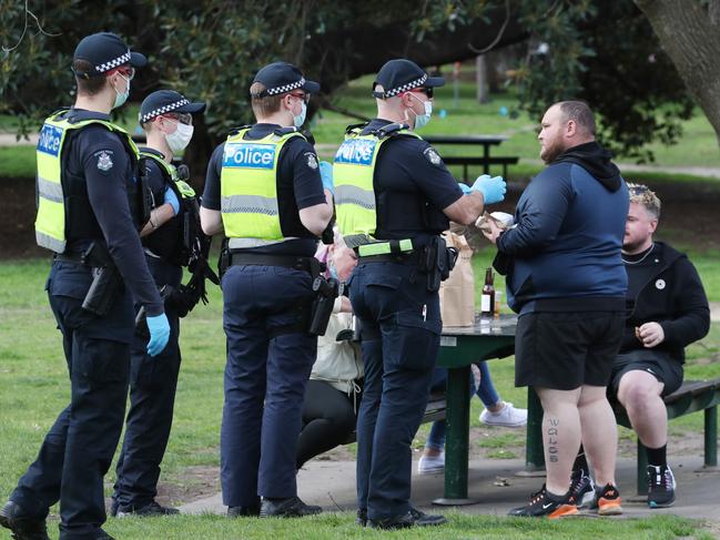 Police tell people in the park to move on. Picture: David Crosling