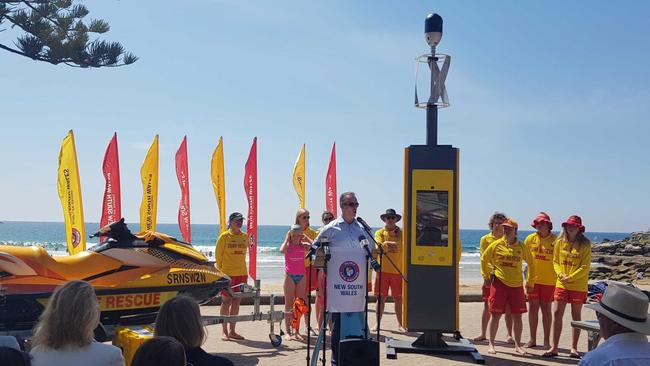 Minister for Police and Emergency Services David Elliott standing alongside a pre-production Emergency Rescue Beacon at Manly’s Shelly Beach. Picture: Surf Life Saving NSW