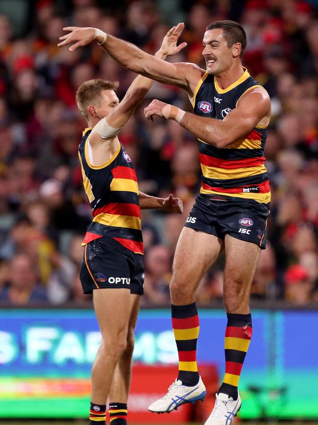 David Mackay celebrates a goal with co-captain Taylor Walker. Picture: James Elsby/AFL Photos/Getty Images