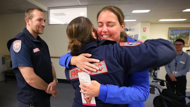 Petra hugs paramedic Georgia Barker and Mica Paramedic Simon Fraser after they brought her back to life. Picture: David Caird