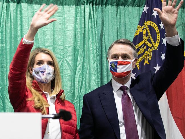 PERRY, GA - NOVEMBER 19: (R to L) U.S. Sen. David Purdue (R-GA) and Sen. Kelly Loeffler (R-GA) wave to the crowd of supporters at a "Defend the Majority" rally with Sen. Tom Cotton (R-AR) at the Georgia National Fairgrounds and Agriculture Center on November 19, 2020 in Perry, Georgia. Loeffler and Purdue are facing Democratic U.S. Senate candidates Jon Ossoff and Raphael Warnock in a January 5th runoff race.   Jessica McGowan/Getty Images/AFP == FOR NEWSPAPERS, INTERNET, TELCOS & TELEVISION USE ONLY ==