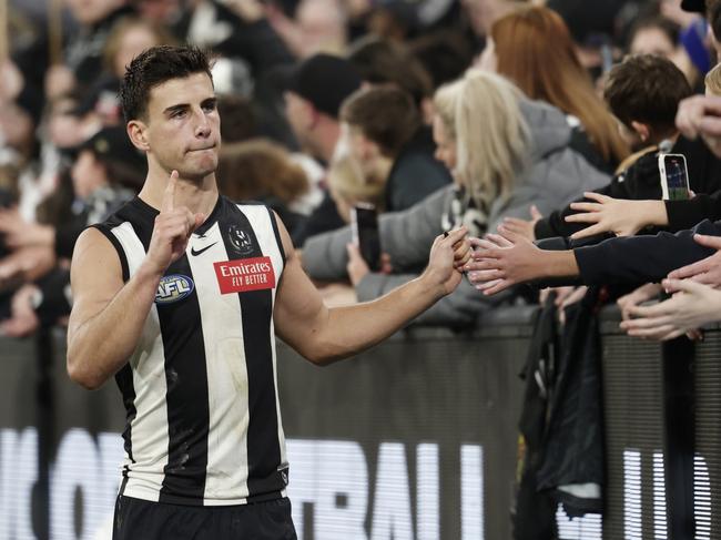 MELBOURNE, AUSTRALIA - AUGUST 17: Nick Daicos of the Magpies celebrates with fans after winning the round 23 AFL match between Collingwood Magpies and Brisbane Lions at Melbourne Cricket Ground, on August 17, 2024, in Melbourne, Australia. (Photo by Daniel Pockett/Getty Images)