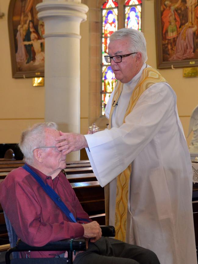 Mr Hayden being baptised by Father Peter Dillon.