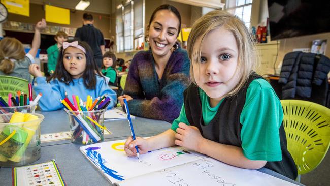 Prep teacher Kathryn Axisa checks Claire's work. Picture: Jake Nowakowski