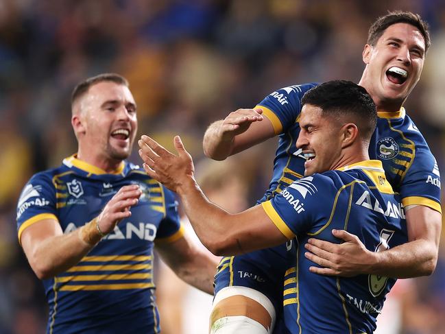 SYDNEY, AUSTRALIA - APRIL 03: Dylan Brown of the Eels celebrates with Clinton Gutherson and Mitchell Moses of the Eels  after scoring a try during the round four NRL match between the Parramatta Eels and the St George Illawarra Dragons at CommBank Stadium, on April 03, 2022, in Sydney, Australia. (Photo by Mark Kolbe/Getty Images)