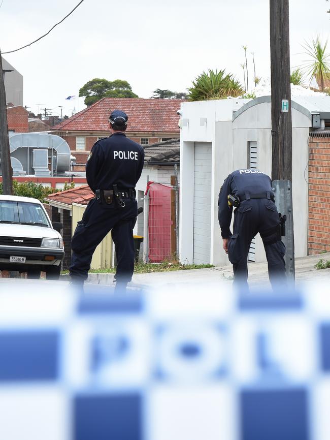 Crime scene officers in the street, following the gangster’s death.