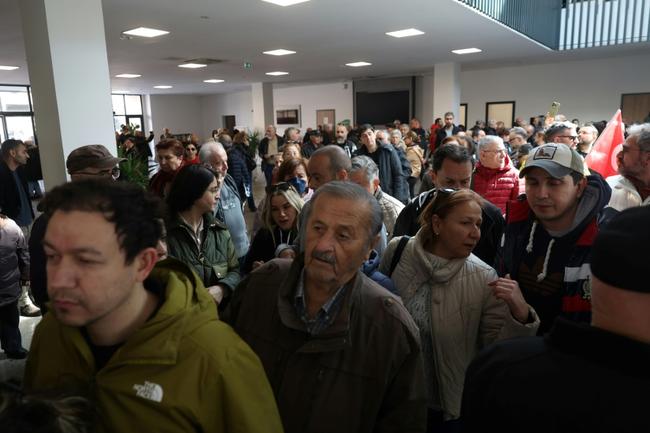 People wait in line to cast their votes at a polling station in Ankara