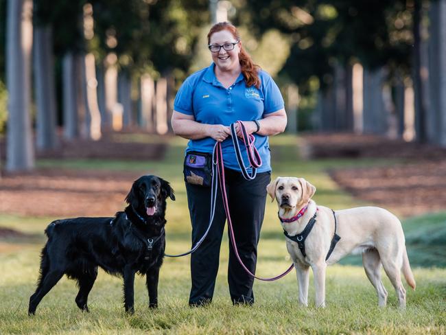 Anne Hardacre, from Pawsitive Connection, with Twist the flat coated retriever and Leala the Labrador. Picture: Supplied