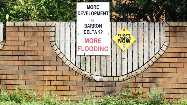 A sign on Machans Street, Machans Beach, opposing further development on flood plains. Picture: Brendan Radke