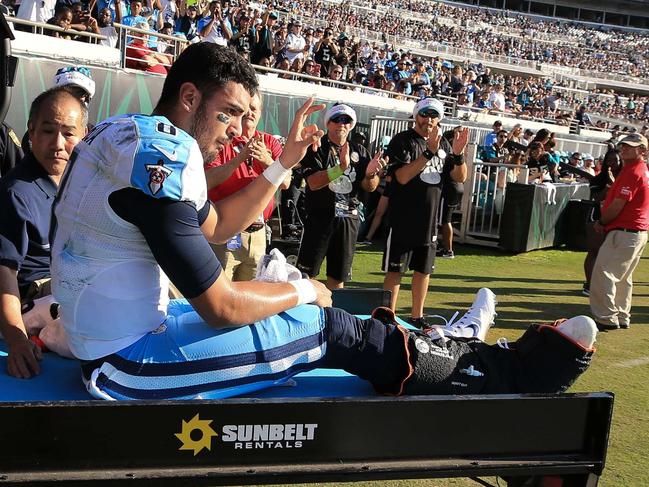 JACKSONVILLE, FL - DECEMBER 24: Marcus Mariota #8 of the Tennessee Titans waves as he is carted off the field after fracturing his fibula during the second half of the game against the Jacksonville Jaguars at EverBank Field on December 24, 2016 in Jacksonville, Florida. Rob Foldy/Getty Images/AFP == FOR NEWSPAPERS, INTERNET, TELCOS & TELEVISION USE ONLY ==