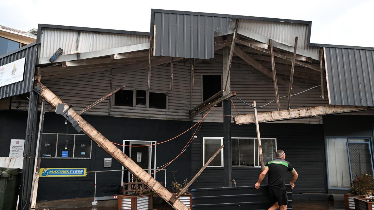 Grant McPherson removes debris from his flood-affected car mechanic business in Lismore. Picture: Dan Peled / Getty Images