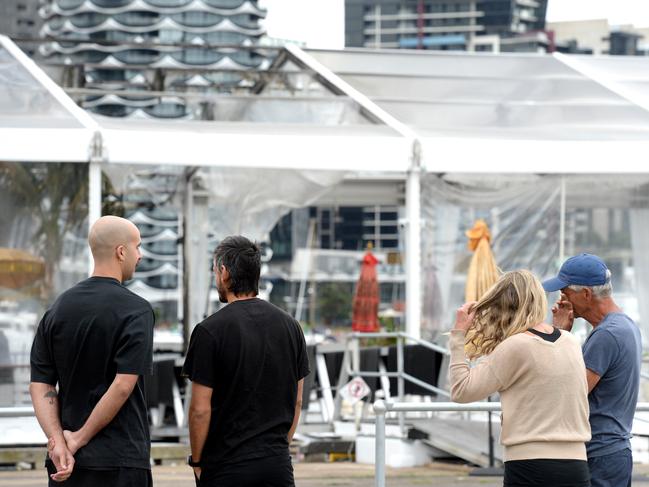 Owners and staff gather at ATET to inspect the damage. Picture: Andrew Henshaw