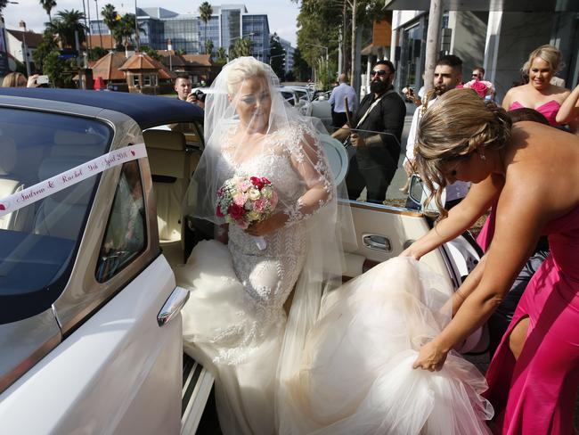 Bride Rachel Carter steps out of one of the many wedding cars on her big day. Picture: David Swift