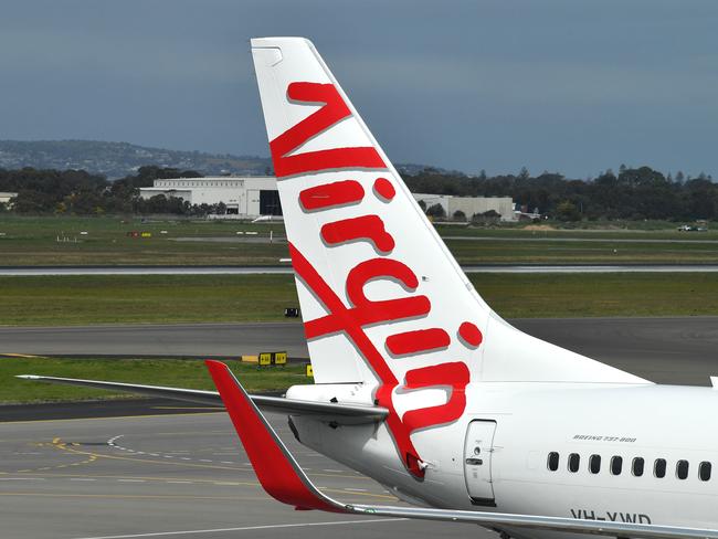 A Boeing 737-800 is seen at the Virgin Australia Airlines terminal at Adelaide Airport in Adelaide, Wednesday, August 28, 2019. Virgin Australia has reported a full-year loss of $349.1 million, saying it will cut 750 corporate and head office positions. (AAP Image/David Mariuz) NO ARCHIVING
