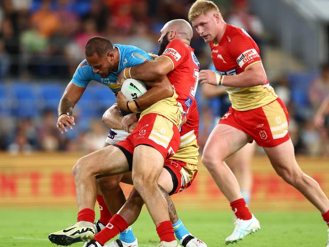 GOLD COAST, AUSTRALIA - MARCH 30: Phillip Sami of the Titans is tackled during the round four NRL match between Gold Coast Titans and Dolphins at Cbus Super Stadium, on March 30, 2024, in Gold Coast, Australia. (Photo by Chris Hyde/Getty Images)