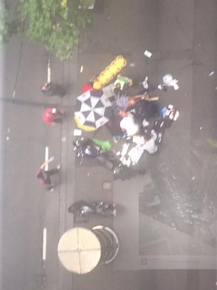 Onlookers tending to a victim who was hit by the speeding car.