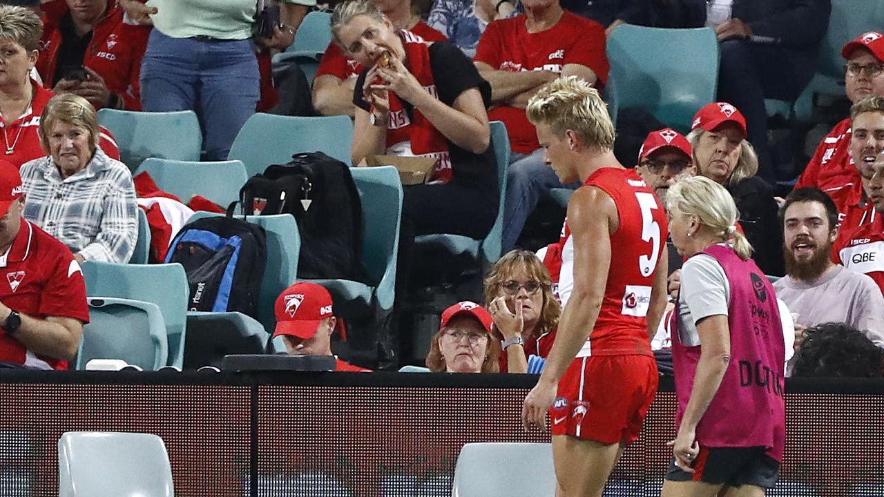 Isaac Heeney of the Swans leaves the ground after suffering a hand injury. Picture: Getty Images