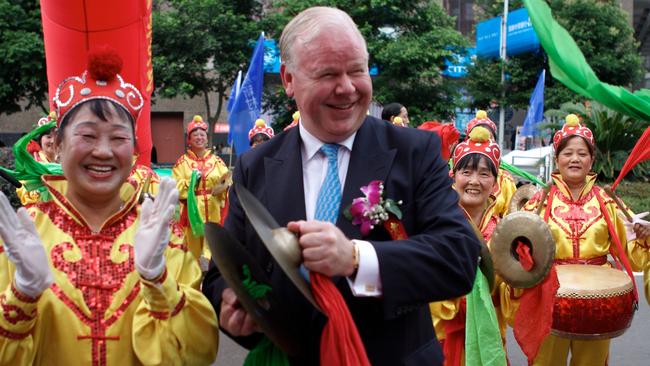 Former ANZ chief executive Mike Smith helps open the bank's first rural branch in Chongqing, China. The current CEO says that recent moves are “absolutely not about getting out of Asia.”