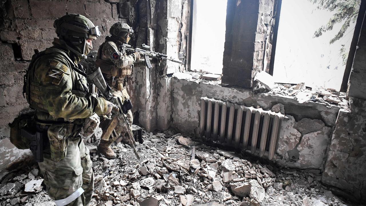 Russian soldier patrol the ruins of the Mariupol drama theatre after it was bombed by Russian troops. Picture: Alexander Nemnov / AFP.