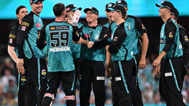 BRISBANE, AUSTRALIA - DECEMBER 22: Nathan McSweeney of the Heat celebrates with team mates after running out Alex Ross of the Strikers during the BBL match between Brisbane Heat and Adelaide Strikers at The Gabba, on December 22, 2024, in Brisbane, Australia. (Photo by Bradley Kanaris/Getty Images)