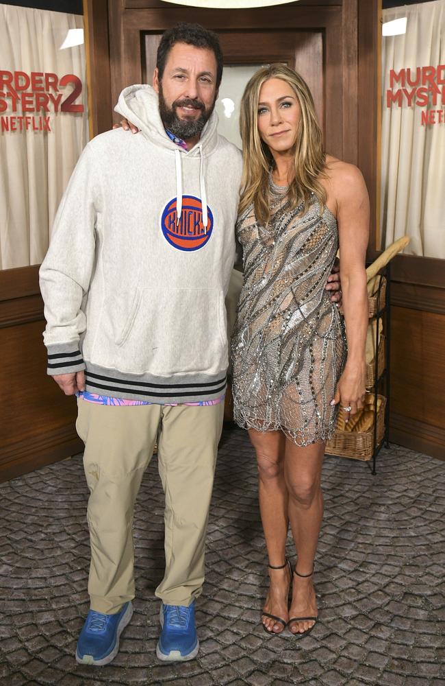 Sandler, pictured with Jennifer Aniston, rocking his signature comfy gear to the glitzy premiere of Murder Mystery 2. Picture: Charley Gallay/Getty Images for Netflix