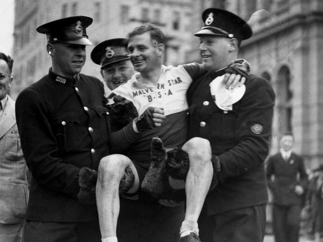 File picture of Sir Hubert Opperman during his cycling days, being carried by two Tasmanian policeman after his record breaking ride from Hobart to Launceston and return. Tasmania.