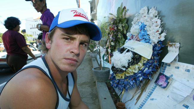 Bali bombing survivor footballer Jake Ryan reading tributes outside Sari nightclub in 2003.