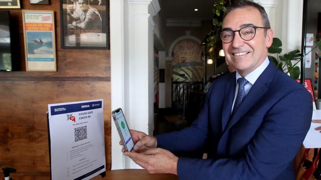 South Australian Premier Steven Marshall demonstrates checking in via QR code at the Stag Hotel. Picture: Kelly Barnes/Getty Images