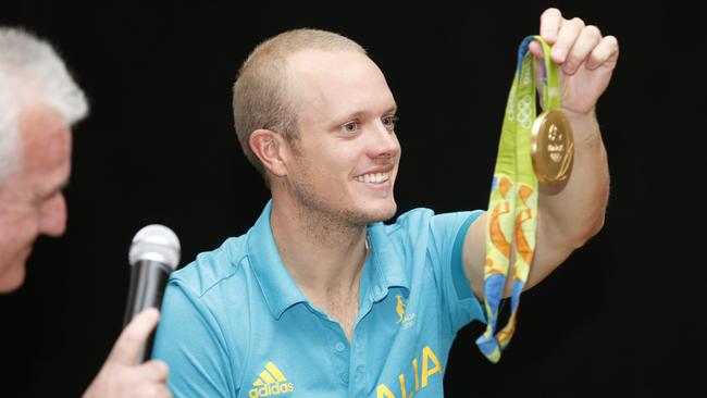 Tom Burton shows off his gold medal.