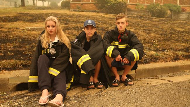 Rayleigh Gould, Riley Gould and Jack Gould worked together to save houses in their street. Picture: Rohan Kelly