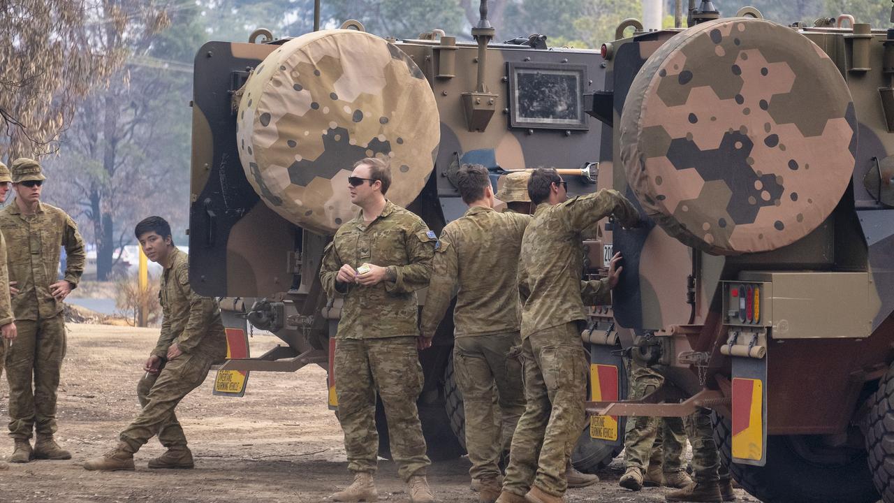 Australian Defence Force personnel take a break after arriving in Mallacoota on January 15, 2020, Australia. Picture: Luis Ascui/Getty Images