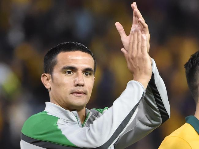 (L-R) Mathew Leckie, Tim Cahill and Jason Davidson of Australia celebrate beating United Arab Emirates in their AFC Asian Cup semi-final football match in Newcastle on January 27, 2015. AFP PHOTO/Peter PARKS --IMAGE RESTRICTED TO EDITORIAL USE - STRICTLY NO COMMERCIAL USE