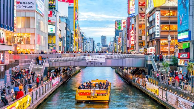 Tourists at Dotonbori shopping street in Osaka, Japan.