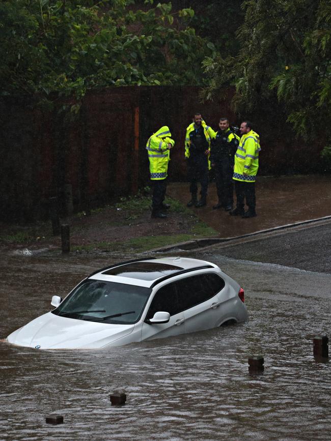 The submerged car gets deeper into the river. Picture: Adam Yip