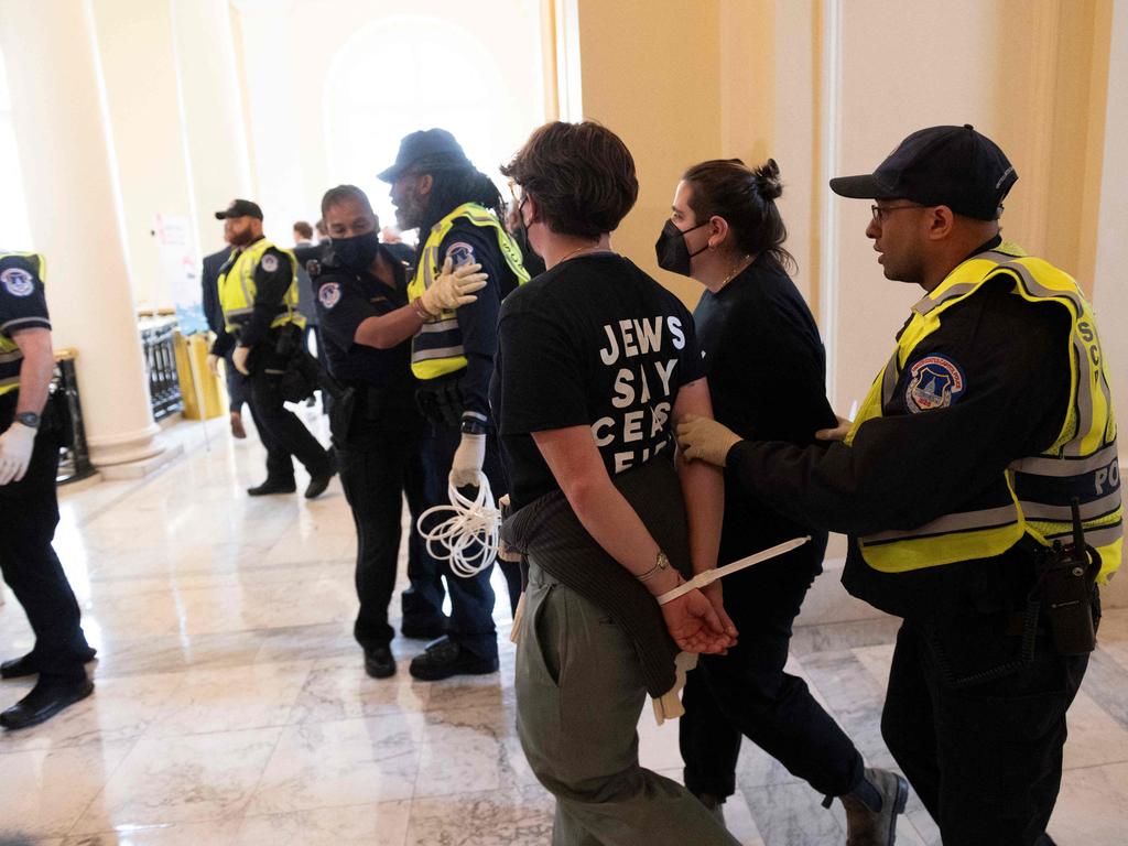 Protesters inside the Cannon building on Capitol Hill are led away by police. Picture: AFP