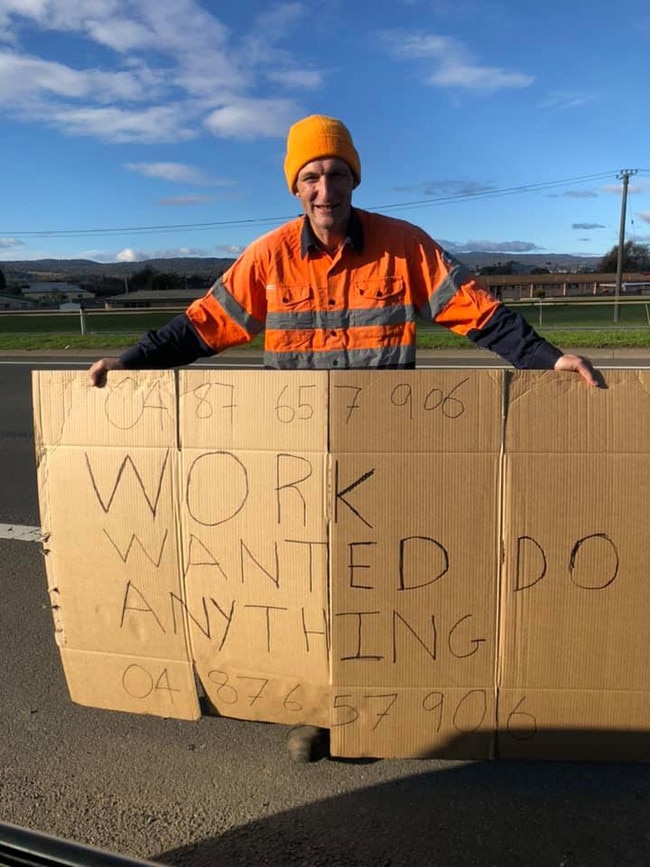 Michael Cann with sign in Launceston looking for work. Picture: Supplied