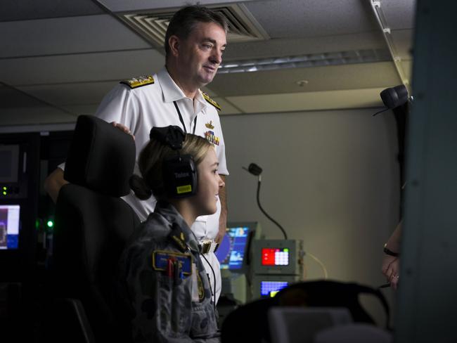 Commander Australian Fleet Rear Admiral Jonathan Mead talks to HMAS Parramatta's Able Seaman Combat Systems Operator Marly Schofield in the Helicopter Frigate Simulator at the Navy Synthetic Warfighting Centre, HMAS Watson, during Exercise Shield Maiden on 23 March 2018. *** Local Caption *** Exercise Shield Maiden is a Navy led, joint-service enabled synthetic training exercise held from 19 to 23 March. The exercise gave Navy personnel the opportunity to train against a medium to  near-peer adversary in a realistic threat environment.  Held in the Navy Synthetic Warfighting Centre at HMAS Watson, six ships contributed officers and sailors to man the Commander Task Unit, Guided Missile Frigate and Frigate Helicopter bridge simulators, as well as the opposing force.