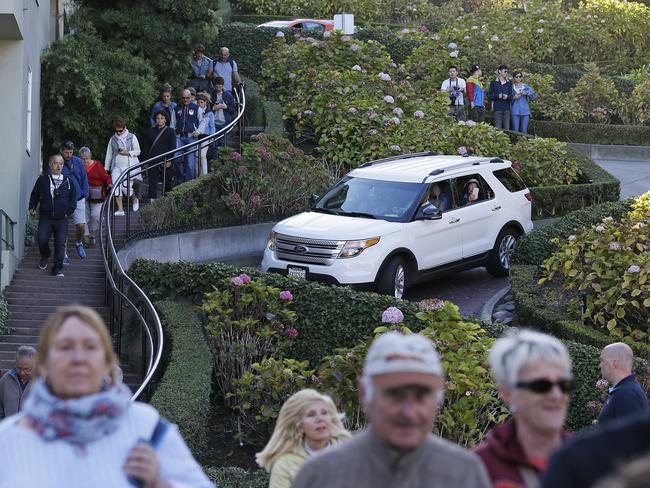 Tourists make their way down the steep, winding thoroughfare. Picture: AP/Eric Risberg